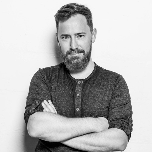 greyscale photo of a man with beard and black tshirt